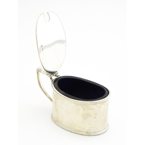 366 - A silver mustard pot with blue glass liner hallmarked Birmingham 1911, maker T H Hazlewood & Co. App... 