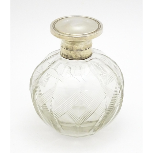 371 - A glass scent / perfume bottle with banded detail, with silver lid hallmarked Birmingham 1918, maker... 