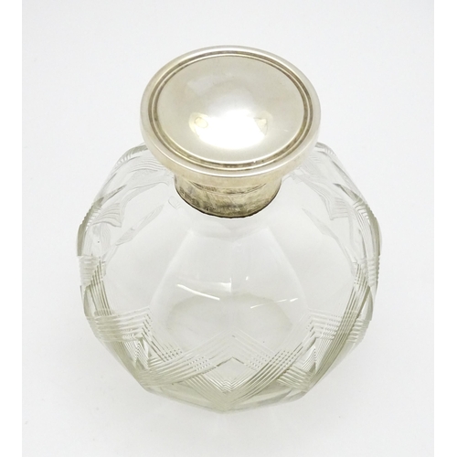 371 - A glass scent / perfume bottle with banded detail, with silver lid hallmarked Birmingham 1918, maker... 