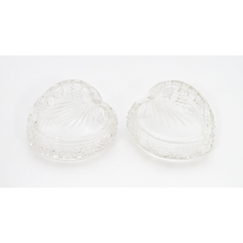 372 - A matched pair of cut glass dressing table pots of heart form with embossed silver lids, hallmarked ... 