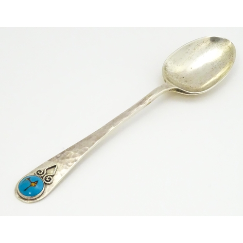 379 - A silver teaspoon with hammered decoration and cabochon detail to handle hallmarked Birmingham 1928,... 