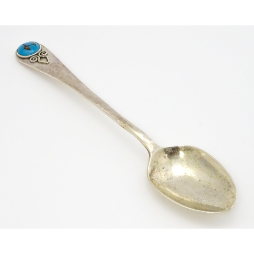 379 - A silver teaspoon with hammered decoration and cabochon detail to handle hallmarked Birmingham 1928,... 