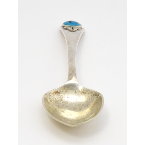 379 - A silver teaspoon with hammered decoration and cabochon detail to handle hallmarked Birmingham 1928,... 