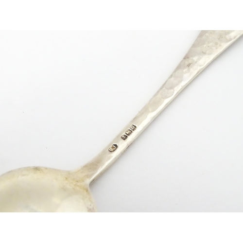 379 - A silver teaspoon with hammered decoration and cabochon detail to handle hallmarked Birmingham 1928,... 