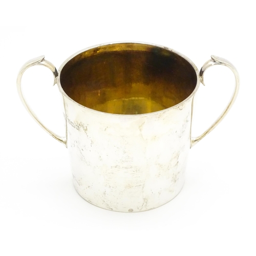 388 - A silver twin handled loving cup with gilded interior, hallmarked Sheffield 1912, maker Atkin Brothe... 