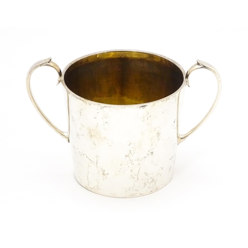 388 - A silver twin handled loving cup with gilded interior, hallmarked Sheffield 1912, maker Atkin Brothe... 