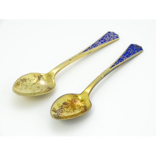 393 - A pair of Art Deco silver gilt teaspoons with enamel decoration to handles, hallmarked Birmingham 19... 