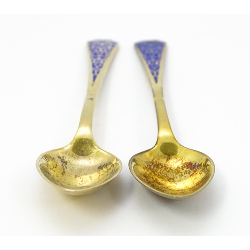 393 - A pair of Art Deco silver gilt teaspoons with enamel decoration to handles, hallmarked Birmingham 19... 