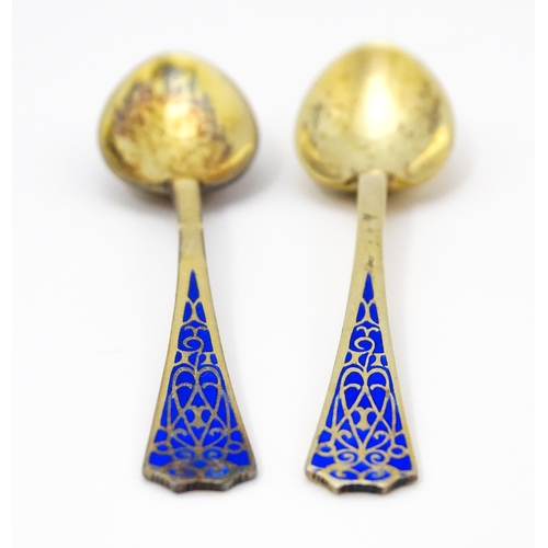 393 - A pair of Art Deco silver gilt teaspoons with enamel decoration to handles, hallmarked Birmingham 19... 