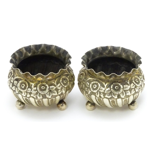 414 - A pair of Victorian silver salts with embossed floral decoration hallmarked Birmingham 1891, maker H... 