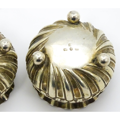 414 - A pair of Victorian silver salts with embossed floral decoration hallmarked Birmingham 1891, maker H... 