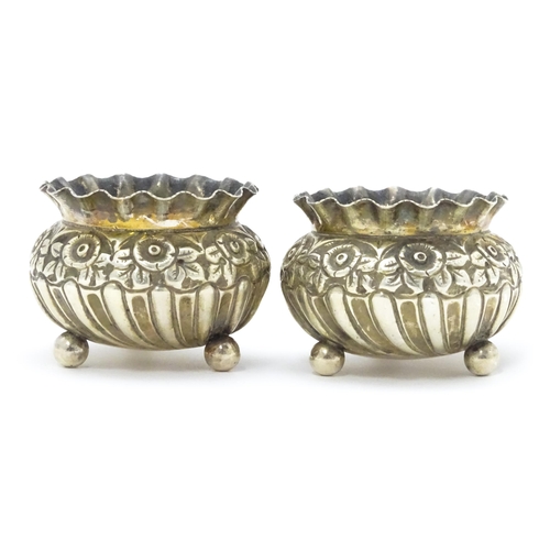 414 - A pair of Victorian silver salts with embossed floral decoration hallmarked Birmingham 1891, maker H... 