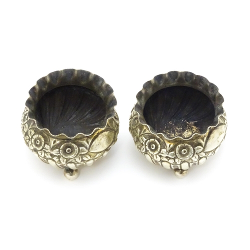 414 - A pair of Victorian silver salts with embossed floral decoration hallmarked Birmingham 1891, maker H... 