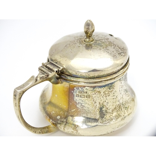 425 - A silver three piece cruet comprising pepper, salt and mustard with matching salt and mustard spoons... 