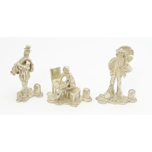 434 - Three silver menu / place card holders of figural form modelled as characters from Cries of London, ... 