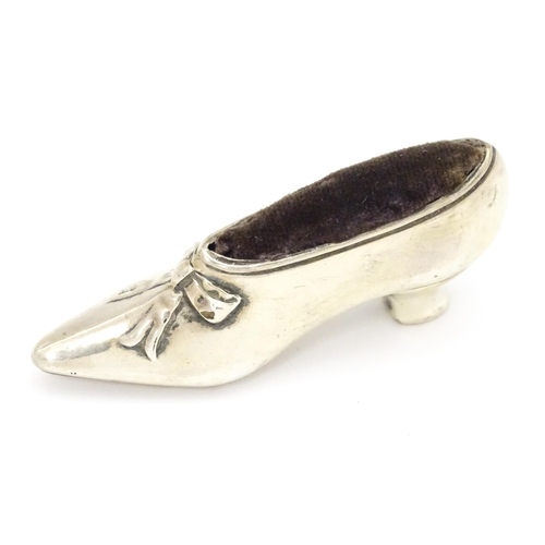 590 - A novelty silver pin cushion of shoe form, hallmarked Birmingham 1906, maker Levi & Salaman. Approx.... 