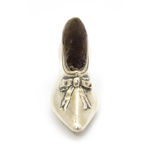 590 - A novelty silver pin cushion of shoe form, hallmarked Birmingham 1906, maker Levi & Salaman. Approx.... 