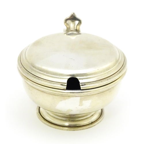 591 - A silver mustard pot with blue glass liner, hallmarked London 1961, maker William Comyns & Sons Ltd.... 