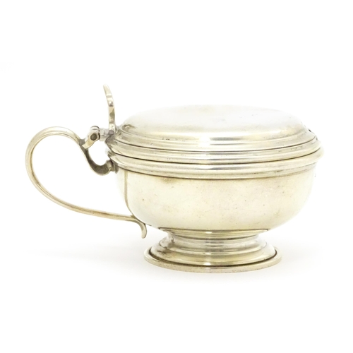 591 - A silver mustard pot with blue glass liner, hallmarked London 1961, maker William Comyns & Sons Ltd.... 