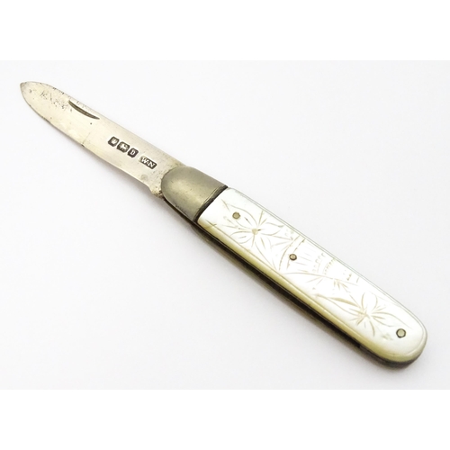 600 - A silver folding fruit knife with engraved mother of pearl handle, hallmarked Sheffield 1913, maker ... 