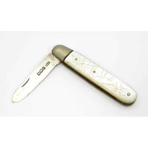 600 - A silver folding fruit knife with engraved mother of pearl handle, hallmarked Sheffield 1913, maker ... 