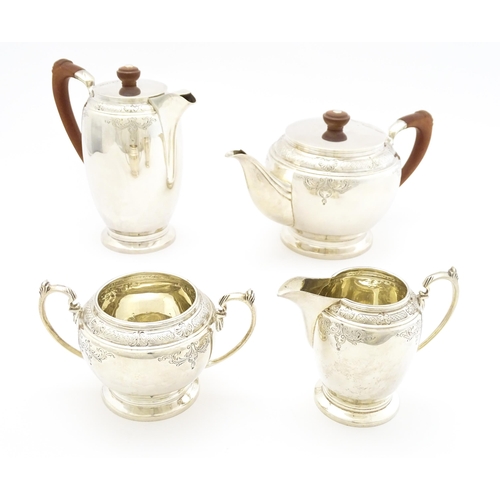 604 - A silver four piece tea set comprising teapot, hot water pot, sugar bowl and milk jug, hallmarked Sh... 