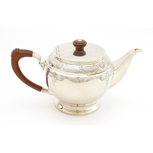 604 - A silver four piece tea set comprising teapot, hot water pot, sugar bowl and milk jug, hallmarked Sh... 