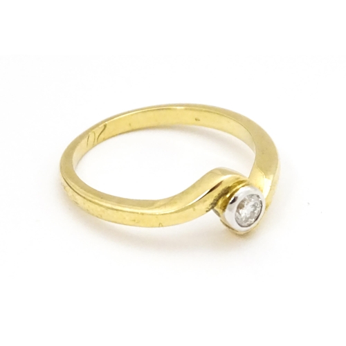 690 - A 9ct gold ring set with central diamond. Ring size approx. O 1/2