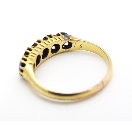 691 - A yellow gold ring set with 5 sapphires.  Ring size approx. J