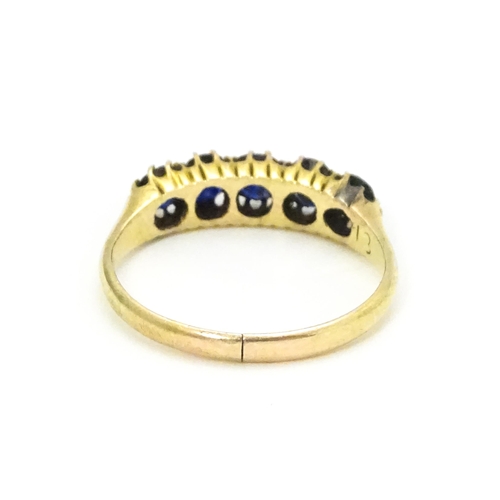 691 - A yellow gold ring set with 5 sapphires.  Ring size approx. J