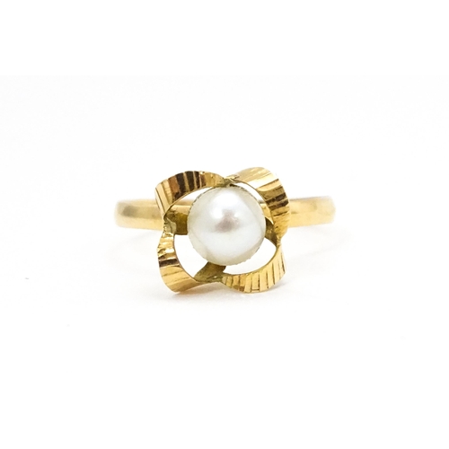 692 - A yellow gold ring set with central pearl Ring size approx. K