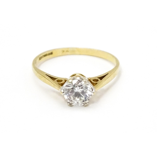 698A - A 9ct gold solitaire ring set with white stone solitaire. Ring size approx. K