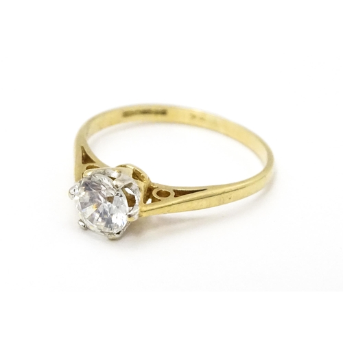 698A - A 9ct gold solitaire ring set with white stone solitaire. Ring size approx. K