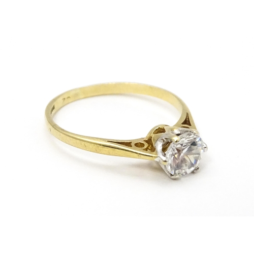 698A - A 9ct gold solitaire ring set with white stone solitaire. Ring size approx. K