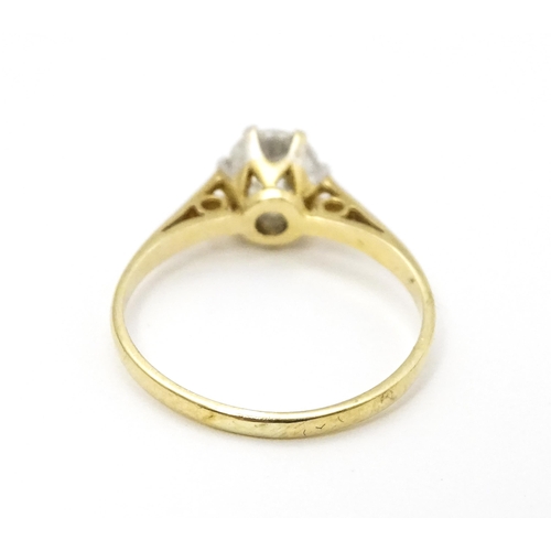 698A - A 9ct gold solitaire ring set with white stone solitaire. Ring size approx. K