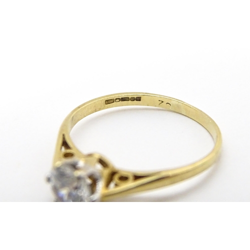 698A - A 9ct gold solitaire ring set with white stone solitaire. Ring size approx. K