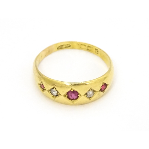 699 - An 18ct gold ring set with rubies and diamonds.  Ring size approx. P