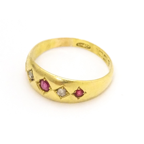 699 - An 18ct gold ring set with rubies and diamonds.  Ring size approx. P