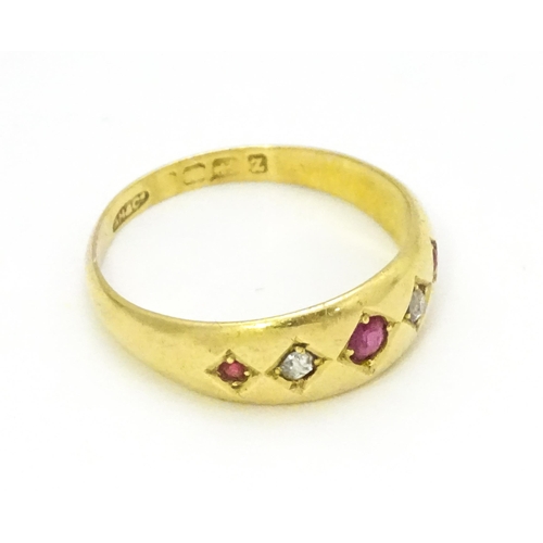 699 - An 18ct gold ring set with rubies and diamonds.  Ring size approx. P