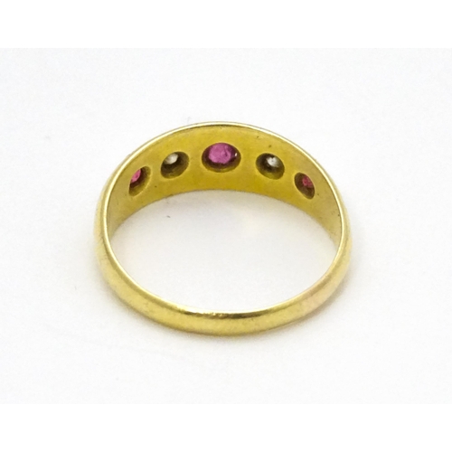 699 - An 18ct gold ring set with rubies and diamonds.  Ring size approx. P