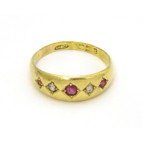 699 - An 18ct gold ring set with rubies and diamonds.  Ring size approx. P