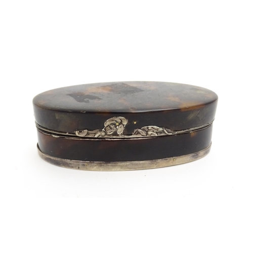 1169 - A 19thC tortoiseshell snuff box of oval form with silver plate mounts. Approx. 3 1/2