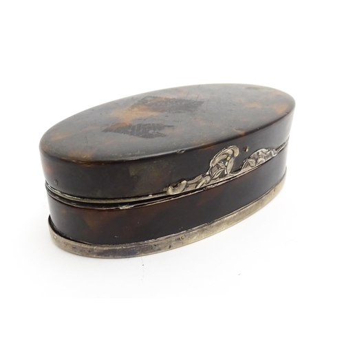 1169 - A 19thC tortoiseshell snuff box of oval form with silver plate mounts. Approx. 3 1/2