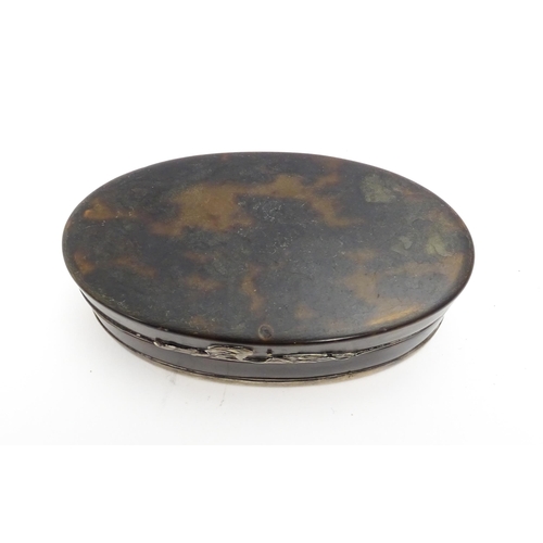 1169 - A 19thC tortoiseshell snuff box of oval form with silver plate mounts. Approx. 3 1/2