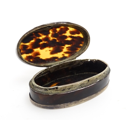 1169 - A 19thC tortoiseshell snuff box of oval form with silver plate mounts. Approx. 3 1/2