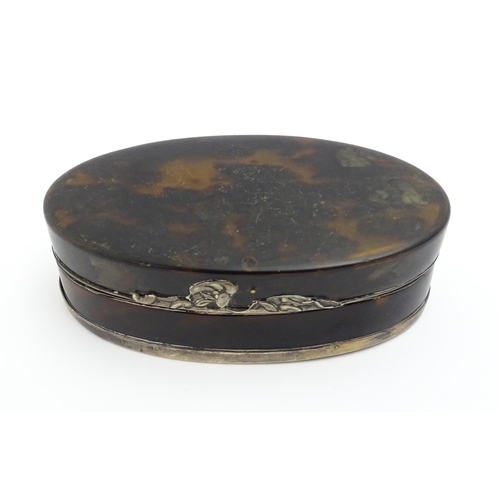 1169 - A 19thC tortoiseshell snuff box of oval form with silver plate mounts. Approx. 3 1/2