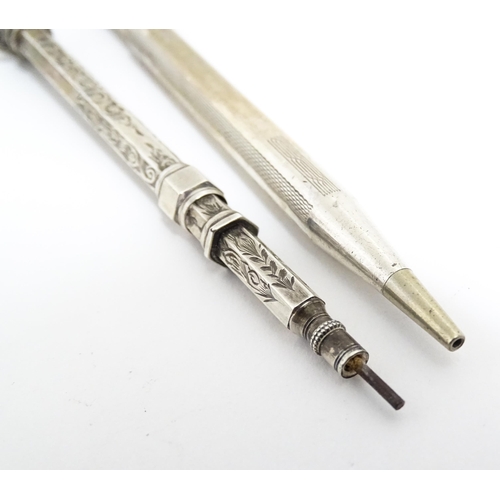 1218 - Two silver propelling pencils one with engraved acanthus scroll decoration and seal top marked .925 ... 