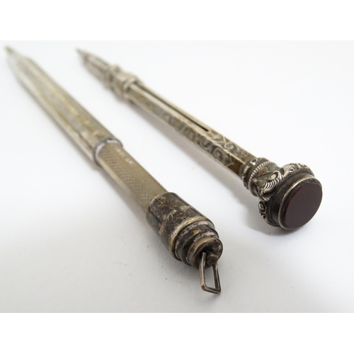 1218 - Two silver propelling pencils one with engraved acanthus scroll decoration and seal top marked .925 ... 