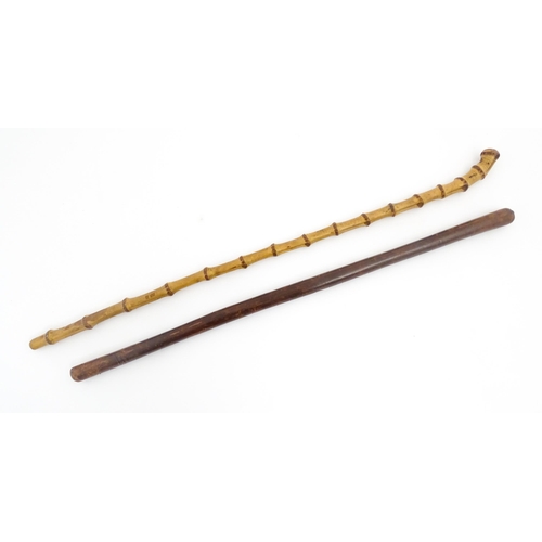 1250 - Two early to mid 20thC Officer's swagger sticks, comprising a leather covered and bamboo examples, t... 