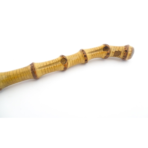 1250 - Two early to mid 20thC Officer's swagger sticks, comprising a leather covered and bamboo examples, t... 